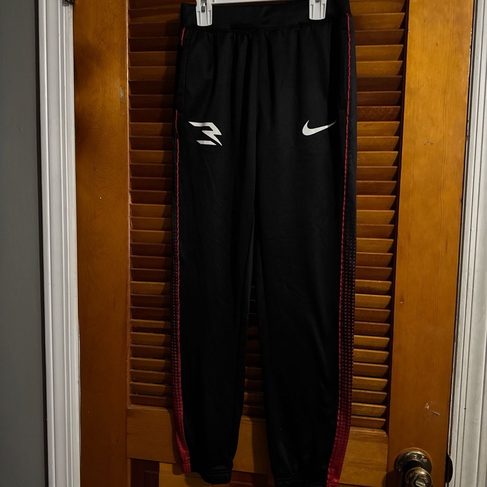 Nike Kids Black Joggers with Red Stripes